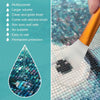 A close-up of a clear puzzle glue droplet being applied with a silicone brush onto a textured surface.