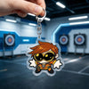 A clear acrylic keychain charm featuring an anime-inspired character with spiky orange hair and goggles.