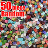 A pile of 50 random colored magnetic building cubes used for creative stacking and construction.