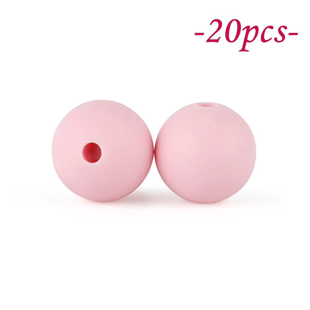 Two pink silicone beads are shown against a white background, indicating a set of soft beads for jewelry making.