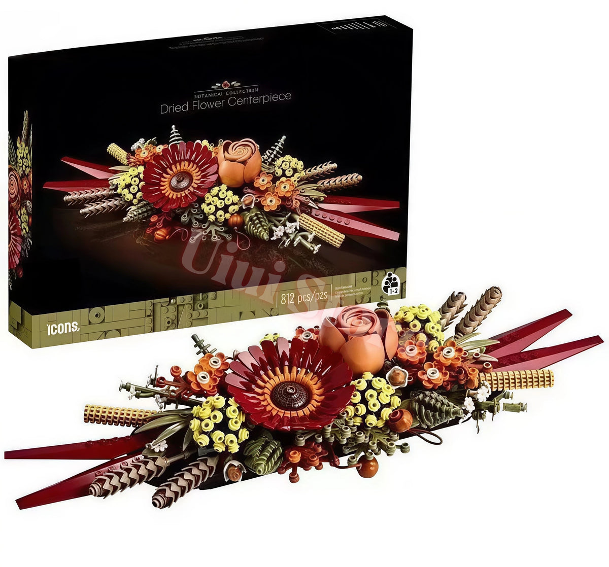 A dried flower centerpiece arrangement featuring roses and various floral elements displayed in a box.