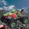 An All-Terrain RC monster truck in green and orange is shown on rocky terrain under a blue sky.