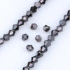 A string of dark gray faceted crystal beads is displayed, showing various geometric shapes and facets.