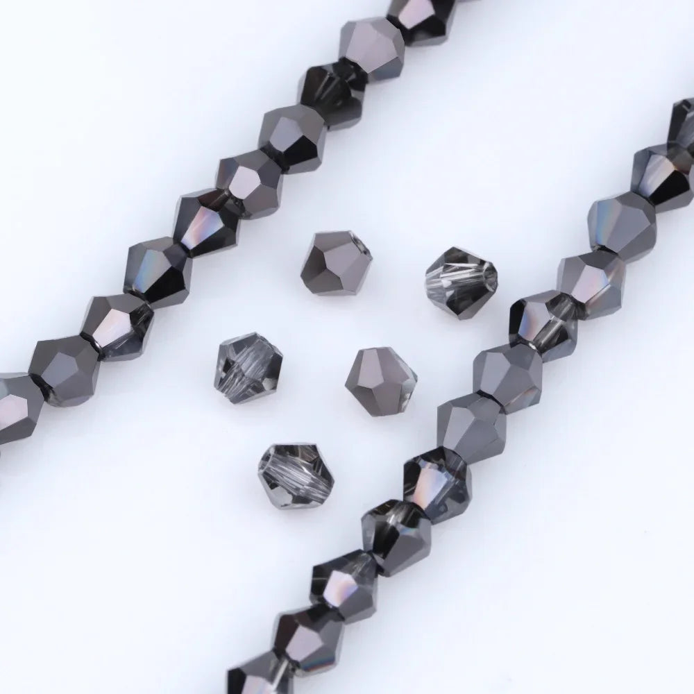 A string of dark gray faceted crystal beads is displayed, showing various geometric shapes and facets.