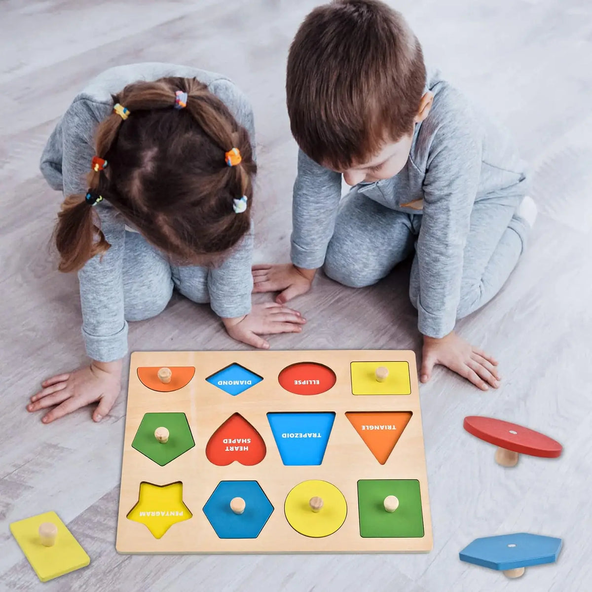 A wooden shape and color sorting puzzle with various geometric shapes and colored pieces is shown on a light surface.