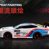 A white and blue 4WD RC drift car with custom paint and black wheels is displayed against a dark background.