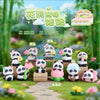 A collection of cute panda blind box figures in various colors and poses displayed on a wooden surface with greenery in the b