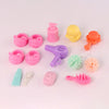 A set of pink and yellow pet spa bath and drying rack playset featuring various grooming tools like a bottle, brush, and comb