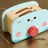 A light blue wooden kitchen play set with realistic food items and a round knob.