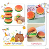 A colorful, squishy burger stress ball toy with a cute bear and bunny design for birthday celebration.