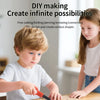 A young boy is using tools to create shapes from cardboard in a DIY making kit.