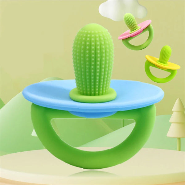 A green silicone teething ring and pacifier tool with a textured nipple is shown on a light green background.