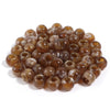 A pile of 50 imitation jade acrylic cloud beads in various shades of brown and amber for jewelry making.