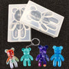 A set of silicone molds shaped like bears for resin jewelry and crafts, including various colors.