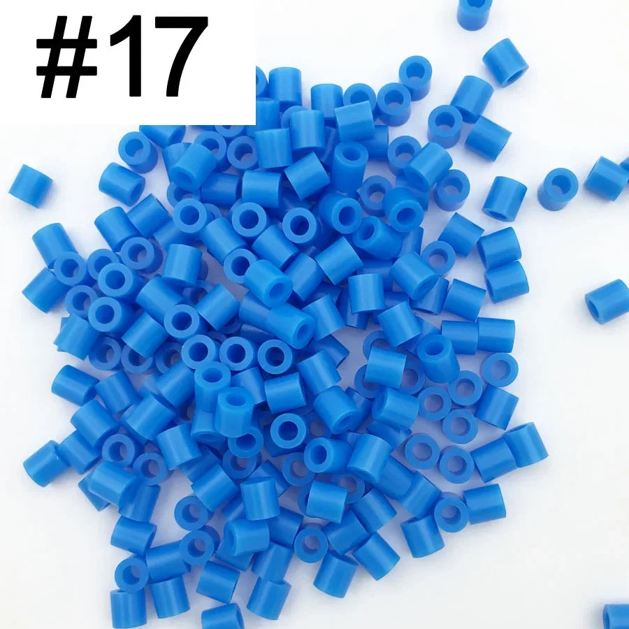 A pile of 1000 small blue fuse beads for creative craft projects.
