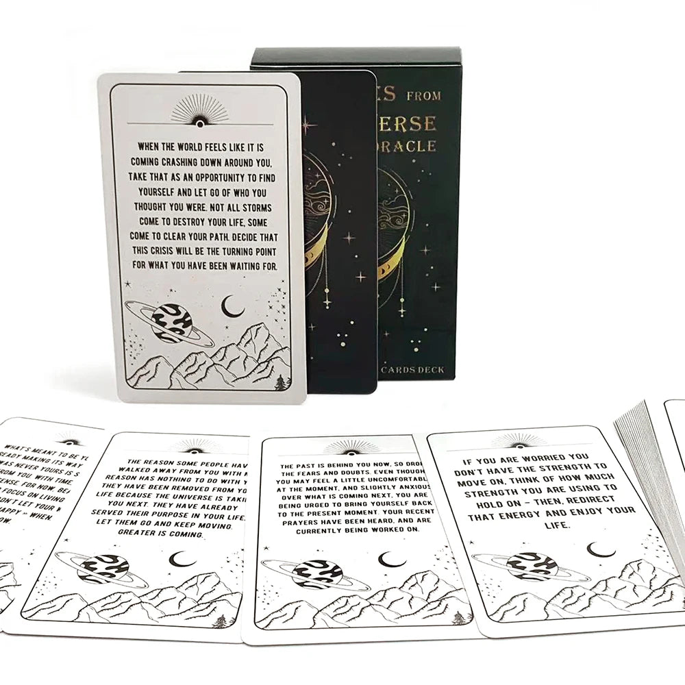 A set of Messages From The Universe Oracle cards in a black box and a white card, featuring celestial imagery.