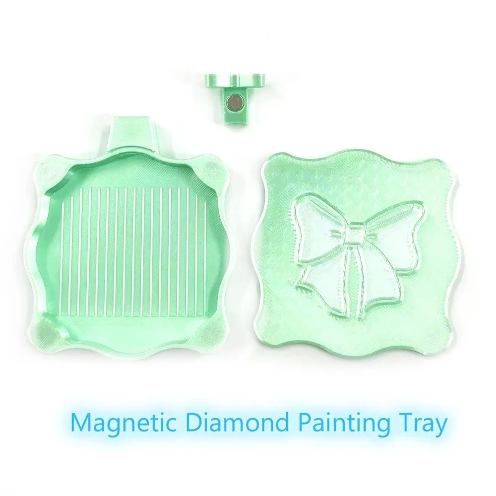 A light green magnetic diamond painting tray with a lid and a decorative bow design.