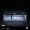 A 1:64 scale LED light-up underground garage diorama featuring a black display box with illuminated interior and a dark surfa