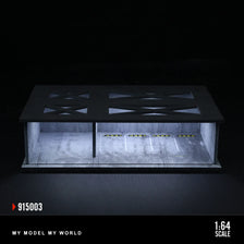 A 1:64 scale LED light-up underground garage diorama featuring a black display box with illuminated interior and a dark surfa