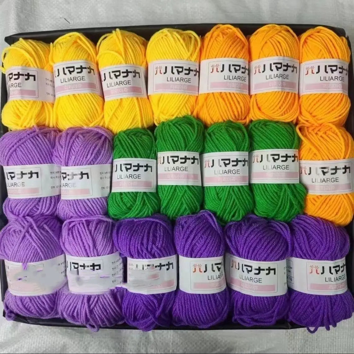 A pack of 20 skeins of soft acrylic wool yarn in various shades of yellow, green, and purple for knitting and crochet.
