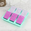 A tray of six silicone soap molds with various lace patterns in pink, purple, and white for handmade soap and DIY crafts