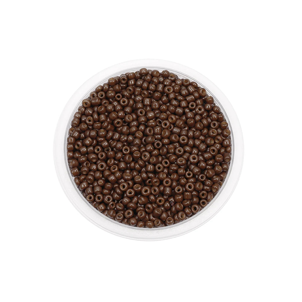 A clear plastic container filled with dark brown Czech glass seed beads for jewelry making