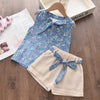 A light blue floral chiffon sleeveless top and matching beige shorts set for a girl.