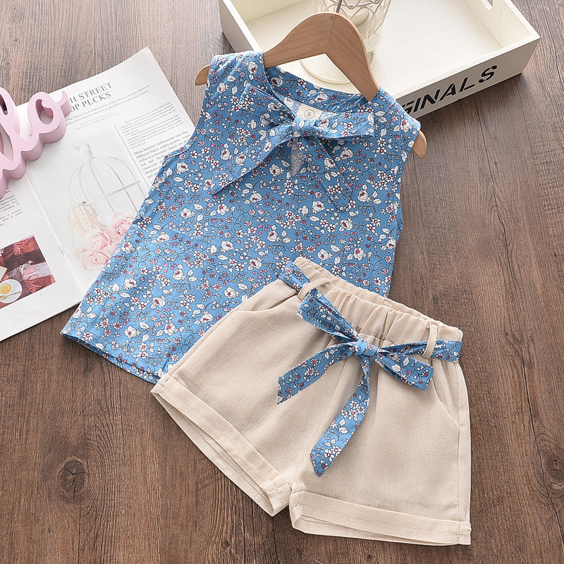 A light blue floral chiffon sleeveless top and matching beige shorts set for a girl.