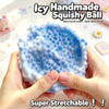A hand holds a blue squishy ball with a honeycomb texture, demonstrating its stretchable quality.
