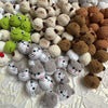 A collection of handcrafted crochet animal keychains in various colors and textures, including rabbits, chicks, cats, and dog