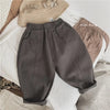 Gray loose wide-leg harem pants for boys displayed on a white surface.