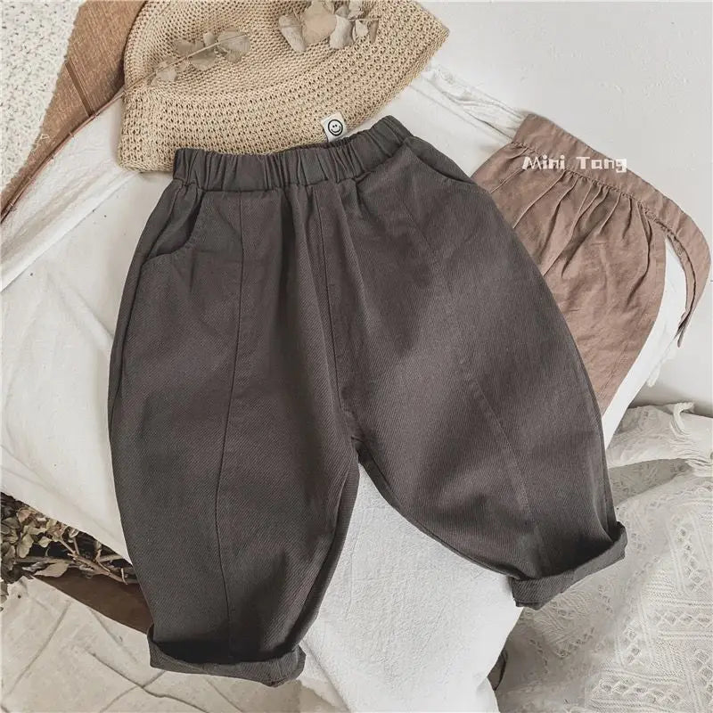 Gray loose wide-leg harem pants for boys displayed on a white surface.