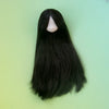 A long, straight black hair doll with a visible face and bangs against a light green background.