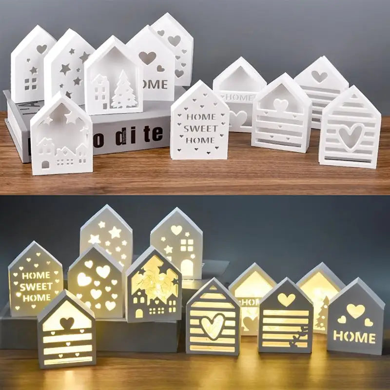 A collection of white and gold silicone molds shaped like houses, featuring hearts, trees, and festive designs.