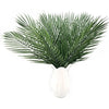 Artificial tropical palm and monstera leaves arranged in a white vase for party decor