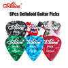 A set of six celluloid guitar picks in various colors including black, red, green, and blue.