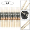 A collection of light wood maple drumsticks labeled 7A and 5A, shown alongside a black container.