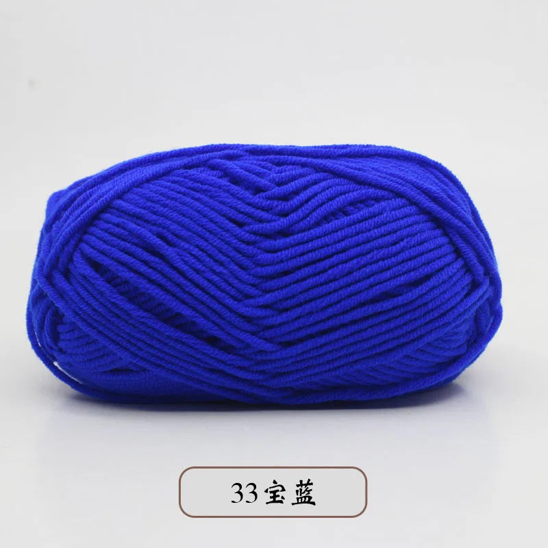 A ball of bright blue pre-dyed milk cotton yarn for knitting and crochet.