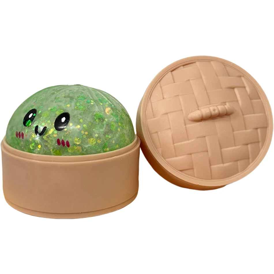 Runde, grüne Glitzer-Squishy-Dumpling-Sensorspielzeug mit passender rosa Deckel.