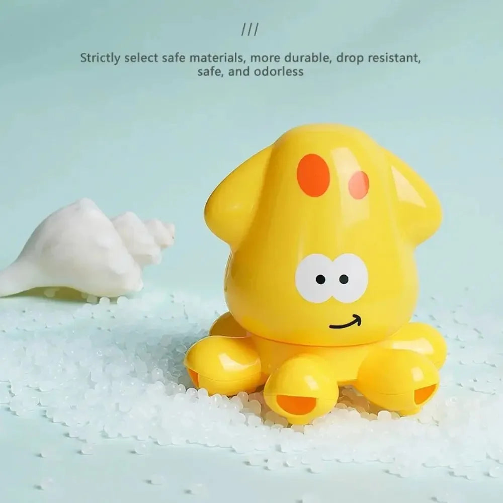A yellow, rubber duck-shaped bath toy is shown resting on white, granular material.