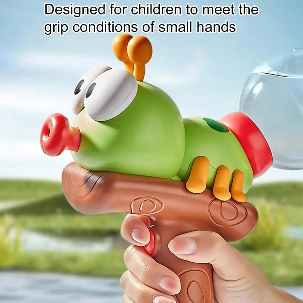 A child's hand holds an ant-shaped water blaster toy with a green body and orange antennae, ready to spray.