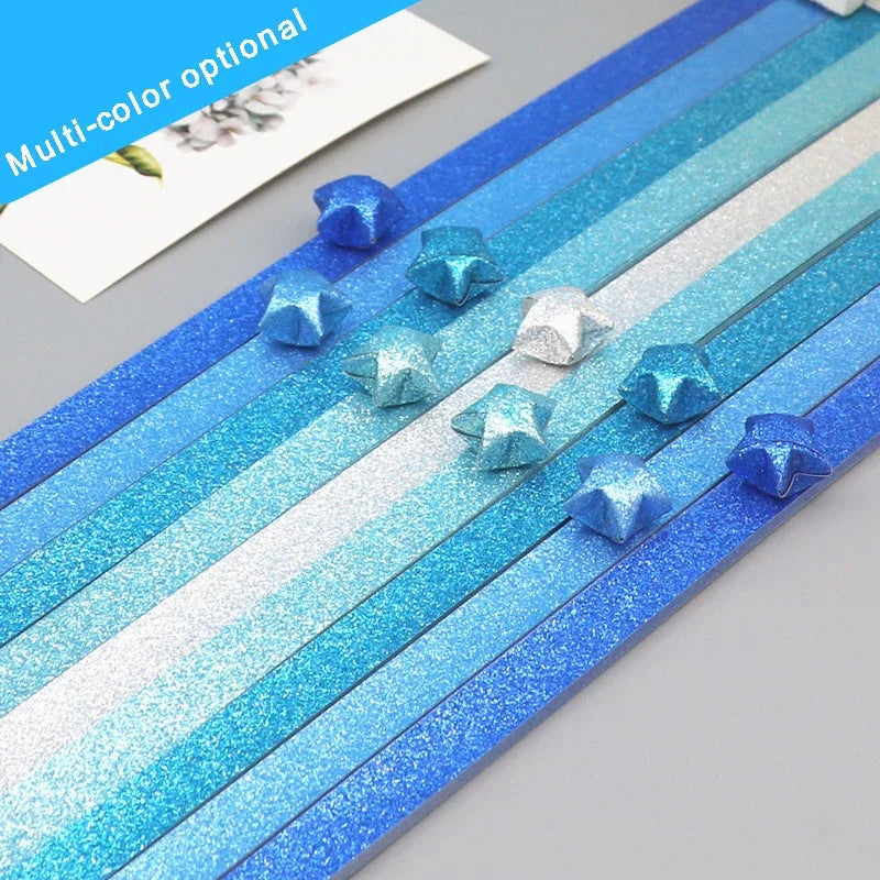 Multi-color glitter origami star paper strips in various shades of blue and silver for crafting