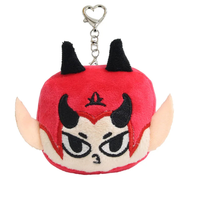 A plush pendant doll resembling a stylized red and black horned face with a silver chain attached.