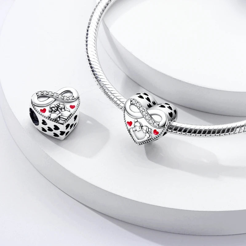 A silver heart charm for bracelets and necklaces is displayed on a white background.