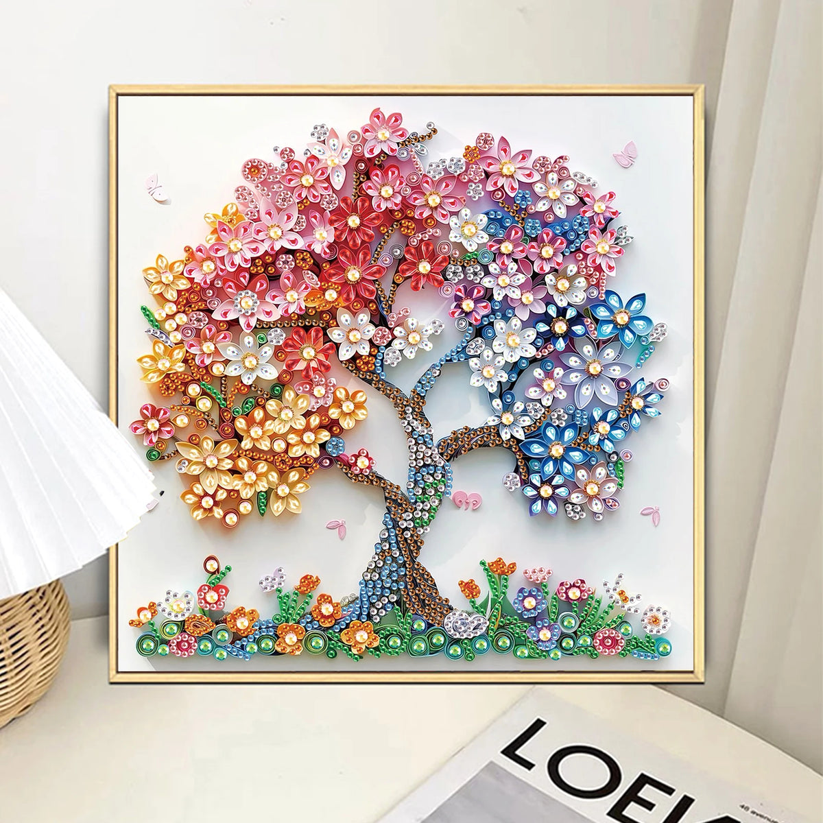 Diamond art painting of a vibrant, colorful tree with pink, orange, and blue blossoms on a white background.