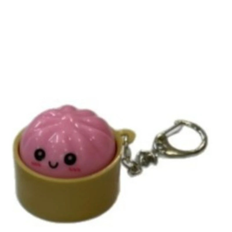 Pink dumpling squishy charm attached to a silver keychain ring