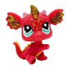 A small, bright red bobble head figurine of a creature with gold accents and large eyes.