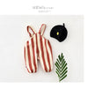 A striped baby romper in brown and cream stripes is displayed next to a black beanie.