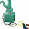 A teal dinosaur-shaped clicker keychain with an LED light is shown being held by a hand.