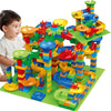 A child is playing with a colorful marble run building blocks maze track toy.
